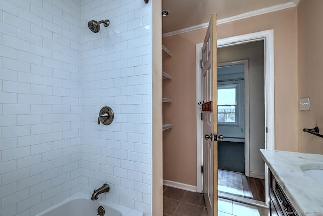 bathroom with vanity, tile patterned flooring, crown molding, and tiled shower / bath