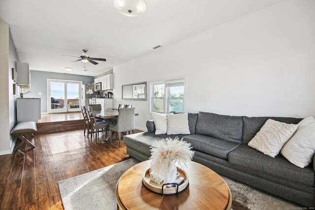 living room with hardwood / wood-style floors and ceiling fan