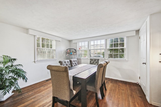 dining room with dark hardwood / wood-style flooring and a textured ceiling