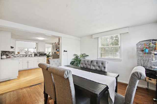 dining area with wood-type flooring