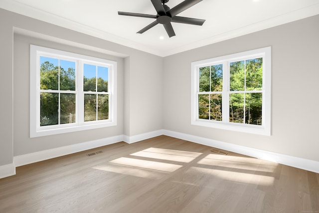 empty room with hardwood / wood-style flooring, ceiling fan, and crown molding