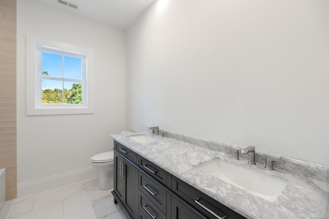 bathroom featuring vanity and toilet