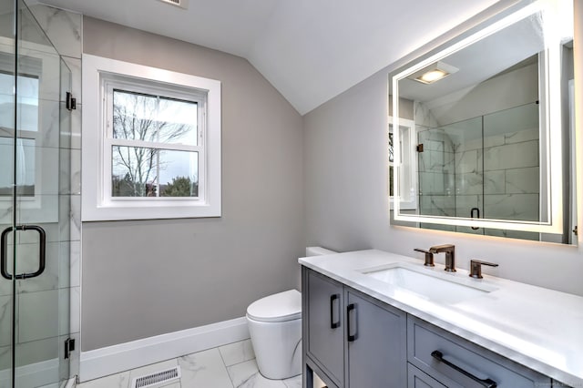 bathroom with a shower with door, vanity, vaulted ceiling, and toilet