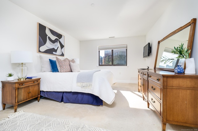 bedroom featuring light carpet