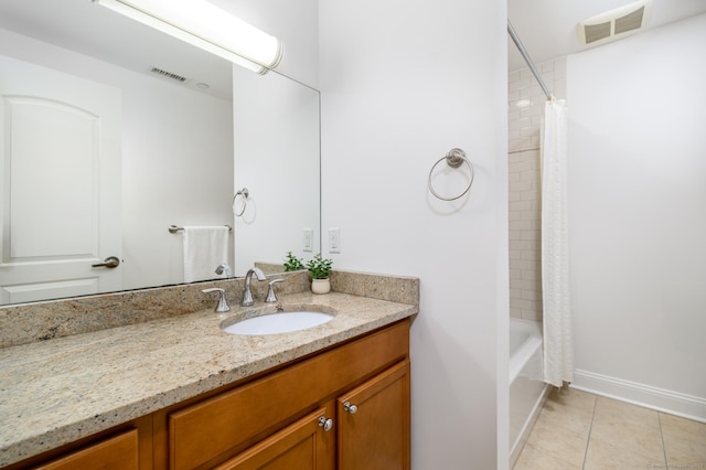 bathroom with shower / bath combo with shower curtain, tile patterned floors, and vanity