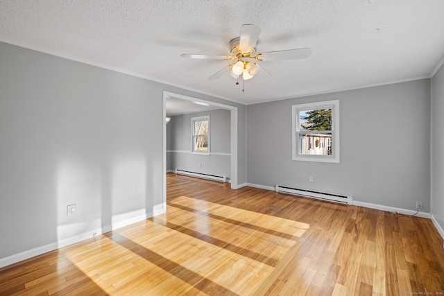 empty room featuring ceiling fan, hardwood / wood-style floors, a baseboard radiator, and ornamental molding