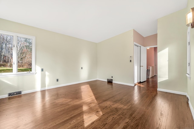 empty room featuring dark wood-type flooring