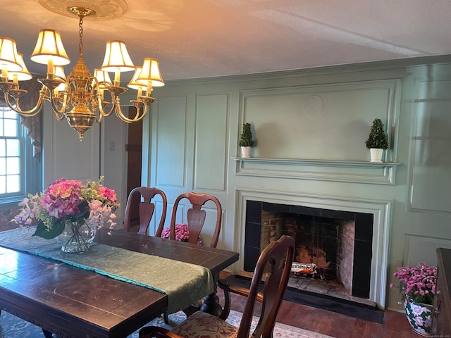 dining space featuring a textured ceiling and dark hardwood / wood-style flooring