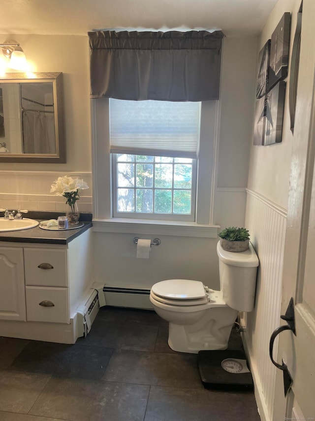 bathroom with tile patterned flooring, vanity, toilet, and baseboard heating