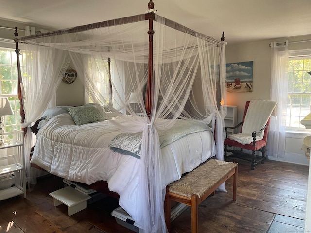 bedroom with dark hardwood / wood-style floors