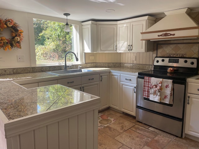 kitchen featuring white cabinetry, hanging light fixtures, backsplash, stainless steel electric stove, and custom exhaust hood