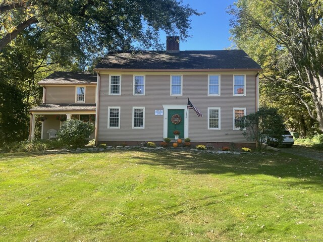 957 Palisado Ave, Windsor, CT 06095 - colonial-style house featuring a chimney and a front yard