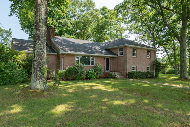 split level home featuring a front lawn