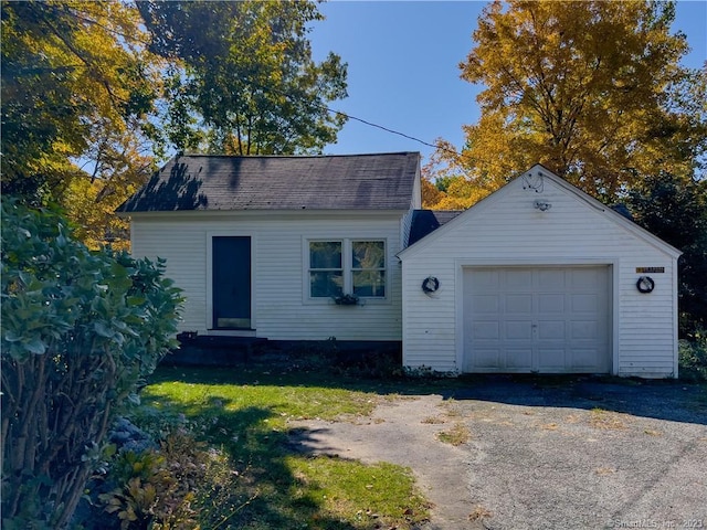 view of front facade with an outbuilding and a garage