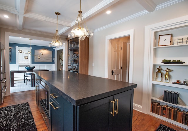 kitchen with beamed ceiling, decorative light fixtures, dark hardwood / wood-style flooring, and appliances with stainless steel finishes