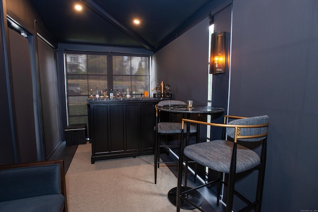 bar featuring carpet flooring and vaulted ceiling