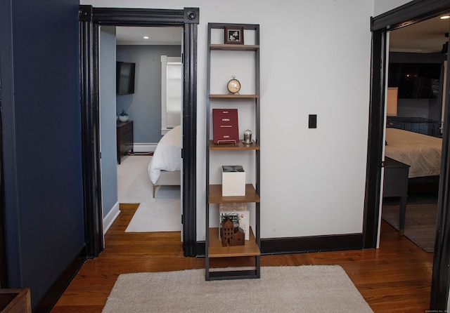 hall with a baseboard radiator and dark wood-type flooring