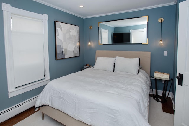 bedroom featuring baseboard heating, crown molding, and hardwood / wood-style flooring