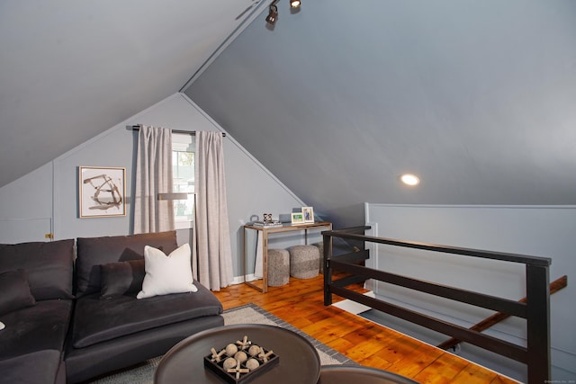 living room featuring hardwood / wood-style floors and vaulted ceiling