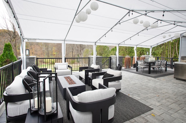 view of patio / terrace featuring an outdoor living space with a fire pit