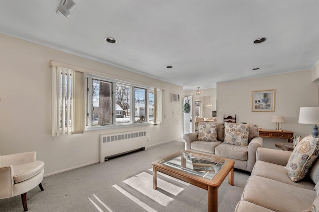 living room with baseboards, radiator heating unit, visible vents, and light colored carpet