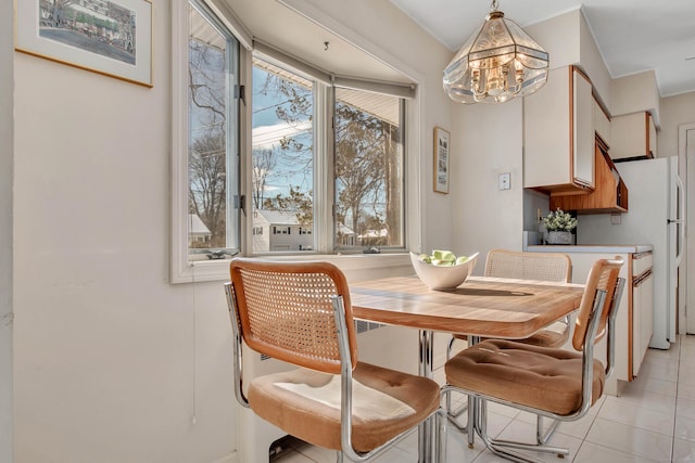 dining room with a notable chandelier and light tile patterned floors