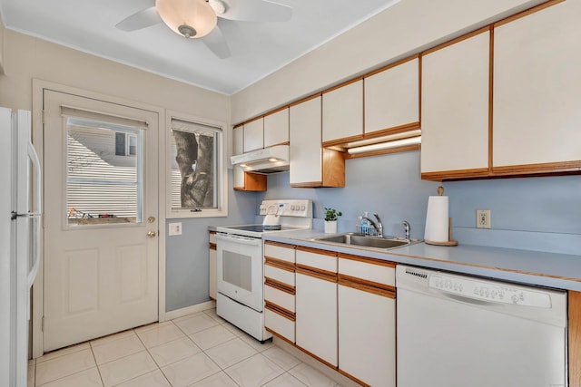 kitchen with light countertops, white cabinetry, a sink, white appliances, and under cabinet range hood