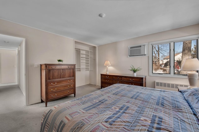 carpeted bedroom with a wall mounted AC and radiator