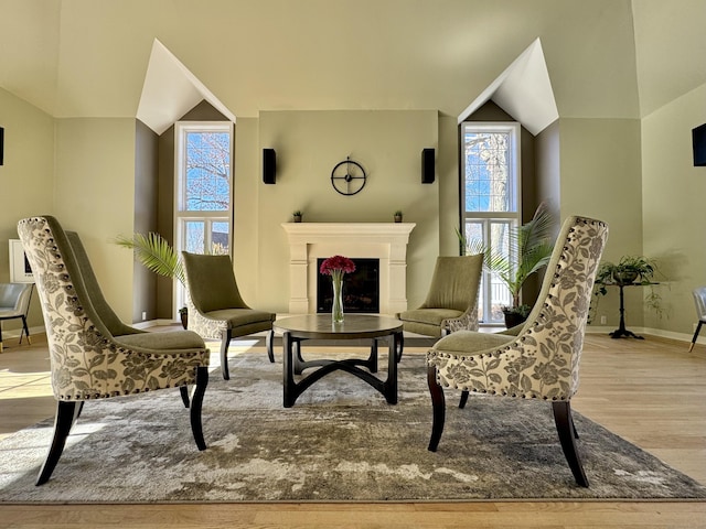 sitting room featuring light hardwood / wood-style floors and vaulted ceiling