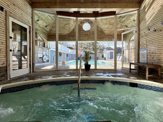 view of swimming pool with an indoor in ground hot tub