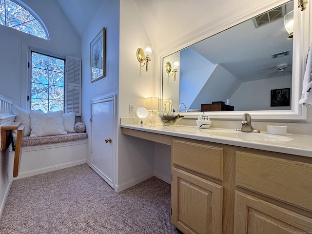 bathroom with vanity, ceiling fan, and lofted ceiling