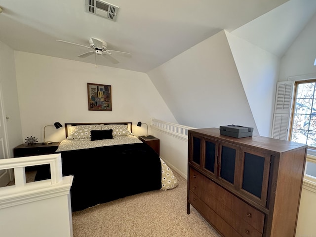 bedroom with light carpet, ceiling fan, and lofted ceiling