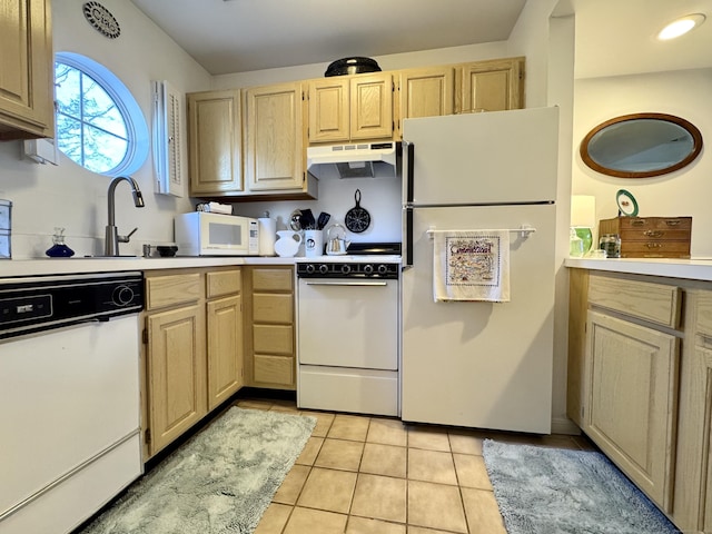 kitchen with light brown cabinets, light tile patterned floors, white appliances, and sink