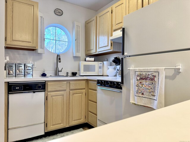 kitchen featuring light brown cabinets, white appliances, and sink