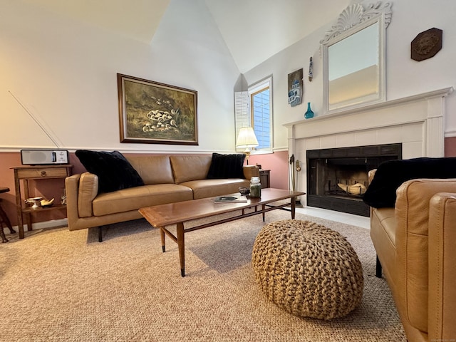 living room with a tile fireplace, light carpet, and high vaulted ceiling