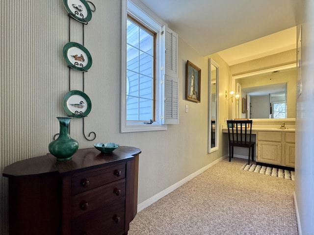 corridor with light carpet and sink