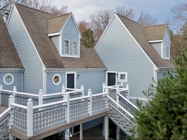 rear view of property featuring a wooden deck