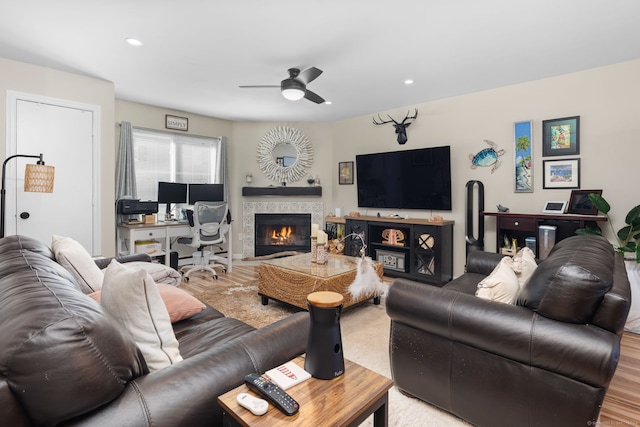 living room featuring ceiling fan and light hardwood / wood-style floors