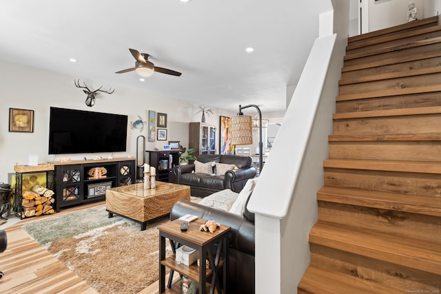 living room with hardwood / wood-style flooring and ceiling fan