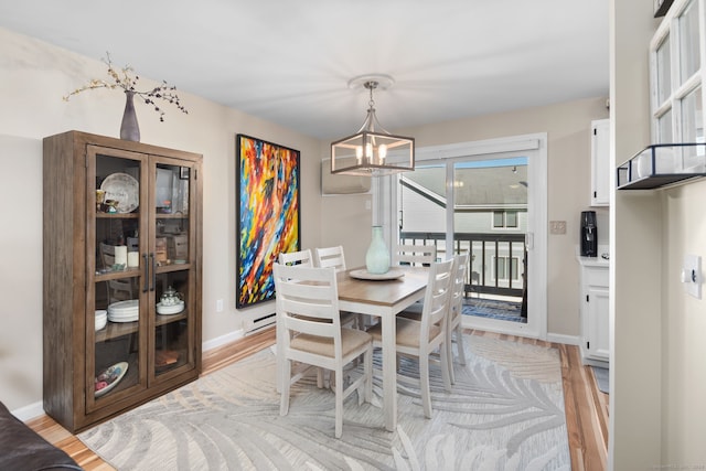 dining area featuring plenty of natural light, light hardwood / wood-style floors, and a notable chandelier