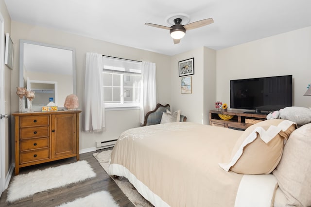 bedroom with ceiling fan, wood-type flooring, and baseboard heating