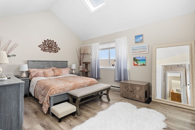 bedroom featuring lofted ceiling with skylight, light hardwood / wood-style flooring, and a baseboard heating unit