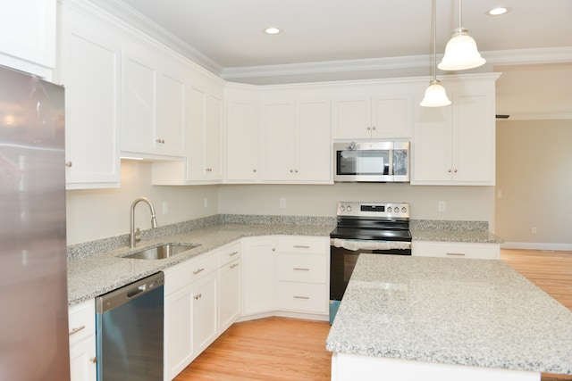 kitchen with white cabinets, stainless steel appliances, hanging light fixtures, and sink