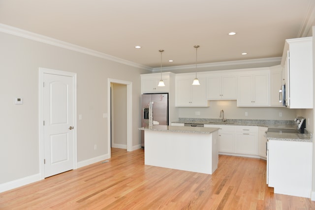 kitchen with a center island, light hardwood / wood-style flooring, white cabinetry, and hanging light fixtures