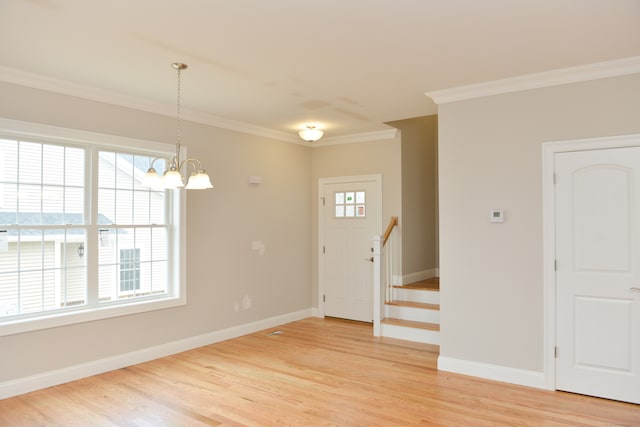 foyer featuring crown molding, plenty of natural light, and hardwood / wood-style floors