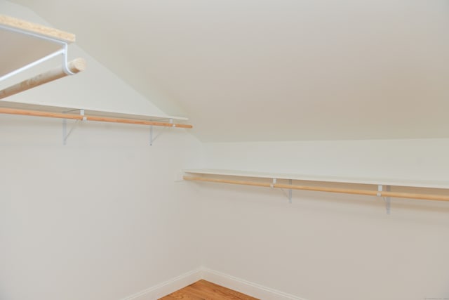 walk in closet featuring vaulted ceiling and hardwood / wood-style flooring