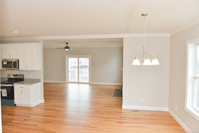 kitchen featuring pendant lighting, white cabinetry, appliances with stainless steel finishes, and light hardwood / wood-style flooring