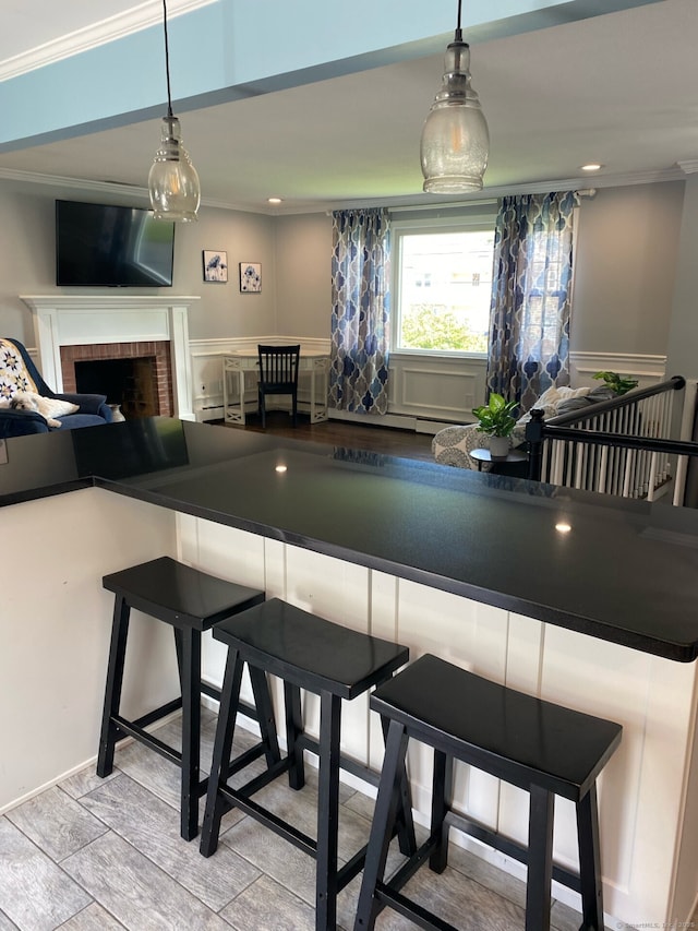 dining space featuring crown molding and a fireplace