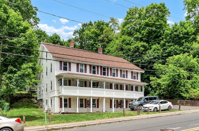 view of front of property with a porch and a balcony