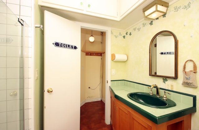 bathroom featuring vanity and an enclosed shower